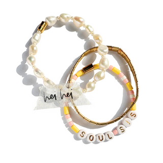 Two beaded bracelets on a white background. One bracelet features irregular white pearls with gold-toned metal accents.