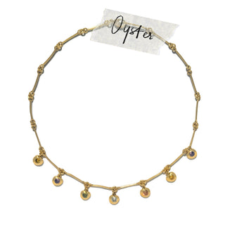 Oyster delicate gold necklace with small multicolour bezel-set gemstone drops along a fine link chain